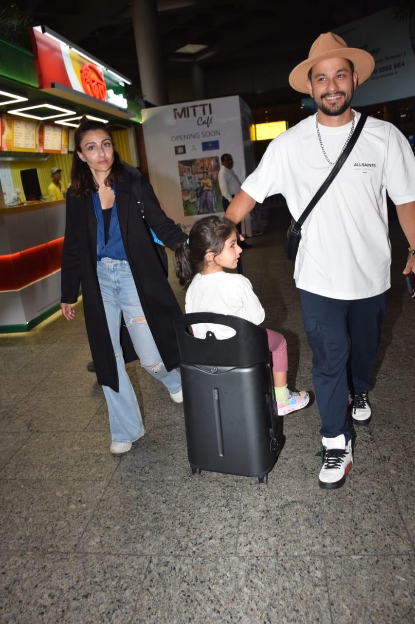 The family of three looked in high spirits to be back in Mumbai